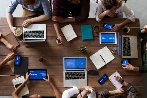 Aerial view of colleagues brainstorming around a meeting table